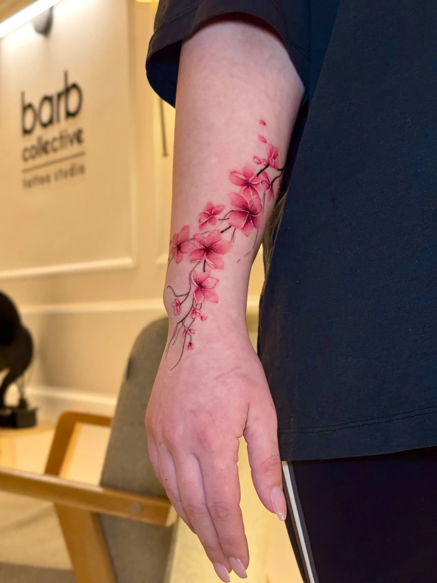 A cherry blossom branch healed along the forearm